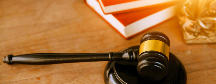 wooden gavel and books on wooden table,on brown background wooden gavel and books on wooden table,on brown background